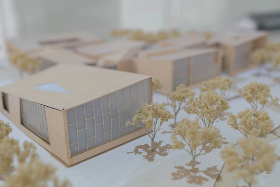 Timber and card massing model of a building on a studio table
