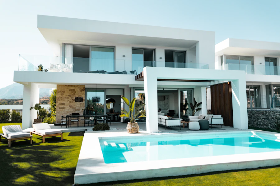 Finished white modern house with a pool and terrace in sunshine